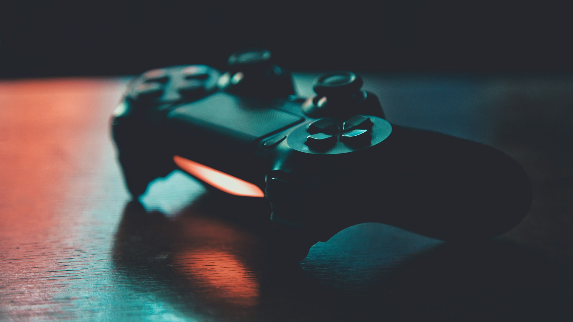 Gaming setup with controllers and glowing screen